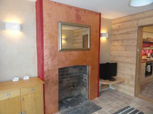 a living room with a fireplace and a television at The Little Luckwell Apartment by Cliftonvalley Apartments in Bristol
