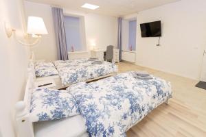 a hospital room with three beds and a flat screen tv at Mia Guesthouse in Haljala