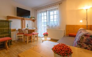 a living room with a couch and a table at Apartmaji Volf in Zgornje Gorje