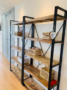 une étagère avec des étagères en bois dans une chambre dans l'établissement Le Zéphyr, superbe appartement à la Corniche avec parking, à Sète