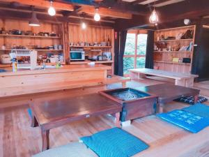 a kitchen with wooden tables and benches in a room at Uenohara - House / Vacation STAY 47885 in Uenohara