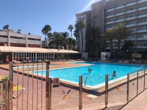 a large swimming pool with people in the water at MAGUI´S PLACE in Playa del Ingles