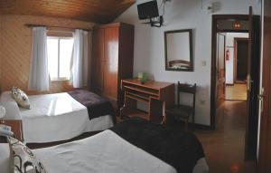 1 dormitorio con 2 camas, escritorio y espejo en Hotel Abrego Reinosa, en Reinosa