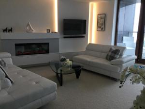 a living room with a couch and a fireplace at Apartament Sea Towers View in Gdynia