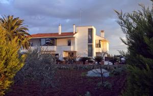 a house with a man in the window of it at B&B Residenza Bianco alle Grotte di Castellana in Castellana Grotte