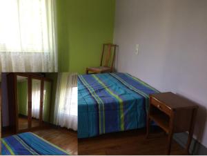 two pictures of a bedroom with a bed and a chair at Petite maison proche de Montbéliard in Sainte-Suzanne