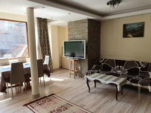 a living room with a couch and a tv at Montana View in Poiana Brasov
