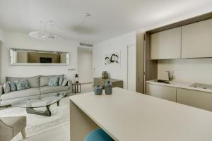 a white kitchen and living room with a couch at Luxury & Exclusive Resort in Saint-Tropez