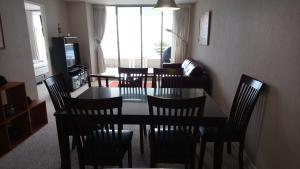 a dining room with a table and chairs and a couch at Apartmento San Alfonso Vista Mar in Algarrobo