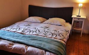 a bedroom with a large bed with a black headboard at Chalupa Levandula in Šumiac