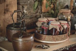 a counter with jars and a pot on a table at Casal dos Capelinhos - Douro in Santa Marta de Penagui&atilde;o