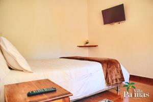 מיטה או מיטות בחדר ב-Hotel Villa Palmas