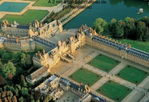 an aerial view of a large castle with water at Studio Saint merry Fontainebleau in Fontainebleau
