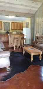 a living room with a table and a kitchen at Teich Hutte Pond Cottage in Rocky Hill