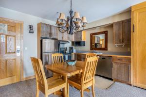 a kitchen with a wooden table and chairs at Shoshone Condo 1950 in Big Sky