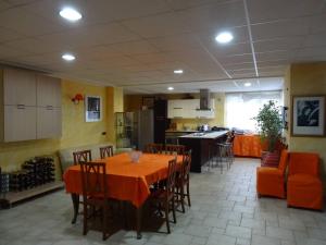 a kitchen and dining room with a table and chairs at Il Sogno in Tivoli