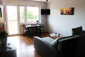 a living room with a couch and a table at Mieszkanie na uboczu Dobrzeń Wielki in Dobrzeń Wielki