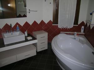 a bathroom with a white tub and a sink at B&B Verdeblu in Valderice