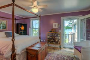 a bedroom with a bed and a ceiling fan at The Spring Lighthouse B&B in Elk Rapids