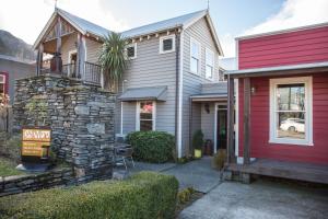 a home with a red and gray house at The Dairy Private Hotel by Naumi Hotels in Queenstown