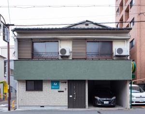 a building with a car parked inside of it at Chikyuutabikazoku USJ Ⅱ in Osaka