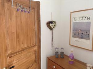 a room with a door and a dresser with a flower on the wall at Haus Edeltraut in Bad Mitterndorf