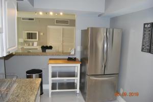 a kitchen with a stainless steel refrigerator and a counter at The Tides Apartment in Hollywood