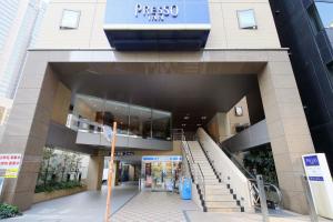 a large building with stairs in front of it at Keio Presso Inn Shinjuku in Tokyo