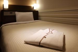 Postel nebo postele na pokoji v ubytování Keio Presso Inn Shinjuku