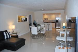 a living room with a couch and a table and chairs at Ocean Reserve Piso 7 STR-310 in Miami Beach