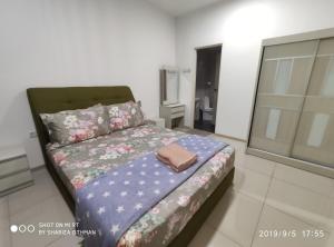 a bedroom with a bed with a blanket on it at Shah Suites Vista Alam in Shah Alam
