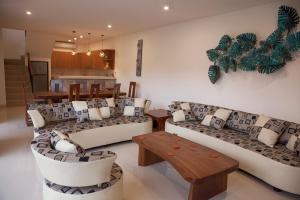 a living room with couches and a table at Pineapple Villa Sanur in Sanur