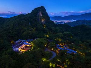 an aerial view of a resort in the mountains at night at Mifuneyama Rakuen Hotel in Takeo +9 photos