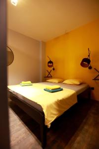 a bedroom with two beds with towels on them at Yellow Black Magic in Thessaloniki