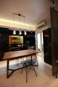 a large kitchen with a wooden table and a chair at Yellow Black Magic in Thessaloniki