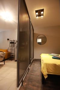 a room with a bed and a mirror at Yellow Black Magic in Thessaloniki