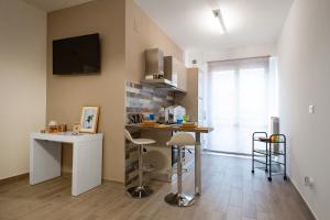 a kitchen with a counter and a table in a room at Quality Apartment Parisina in Pescara
