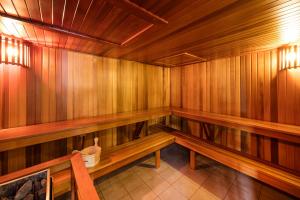 a wooden sauna with wooden benches in a room at Meriton Suites Waterloo in Sydney