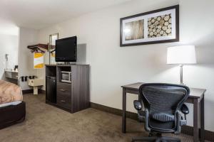 a hotel room with a desk and a chair at Quality Inn in Clare