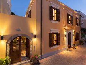 a facade of a building with a door and windows at Rodos Niohori Elite Suites Boutique Hotel in Rhodes Town