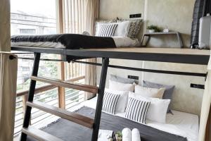 a room with two bunk beds and a window at Vann Bangkok Boutique House in Bangkok