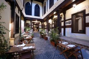 a restaurant with wooden tables and chairs in a building at Deewanji Ni Haveli in Ahmedabad