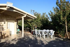 a table and chairs sitting on a patio at שקיעת הדובדבן in Odem