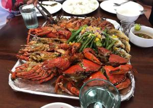 a plate of lobster and other food on a table at Bia's Beach House, Pagudpud in Pagudpud