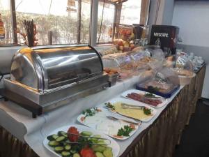 a buffet with several plates of food on a table at Elate Plaza Hotel in Sofia