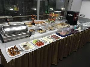 a buffet with many different types of food on a table at Elate Plaza Hotel in Sofia +46 photos