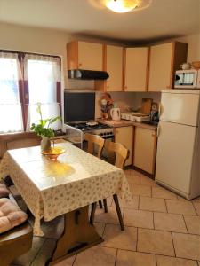 a kitchen with a table and a white refrigerator at Apartment Noemi in Medulin