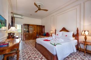 Postel nebo postele na pokoji v ubytování Coco Palm Beach Resort