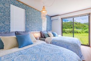 Postel nebo postele na pokoji v ubytování Okinawa Seaside Besso5
