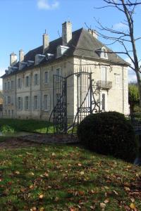une vieille maison avec une porte en face dans l'établissement Château De Serrigny, à Ladoix Serrigny